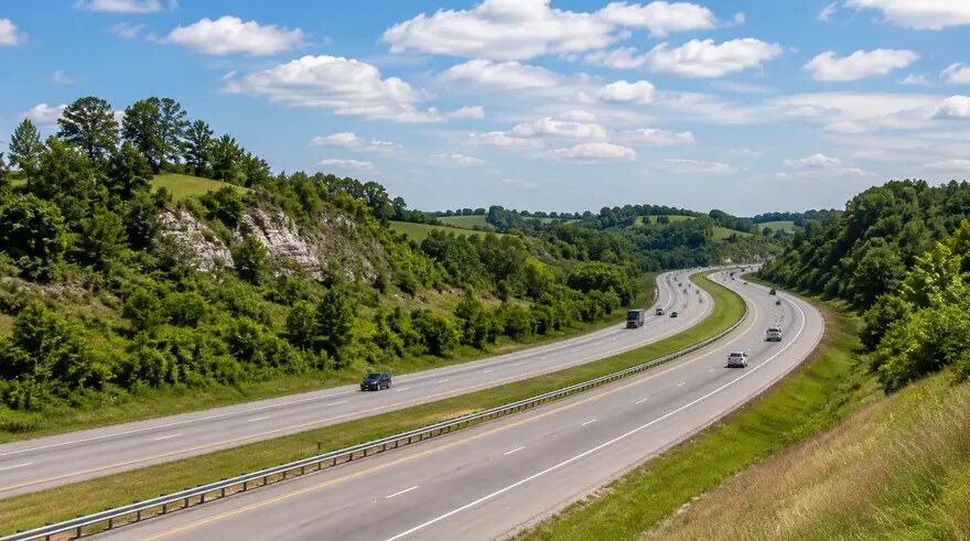 Divided highway curving through Kentucky’s green rolling hills